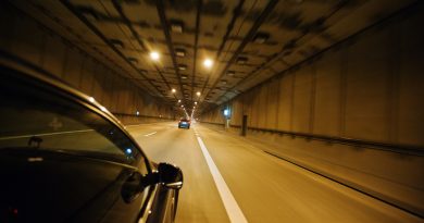 View from the car window, car moving through the tunnel at light